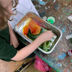 child mixing slime colours
