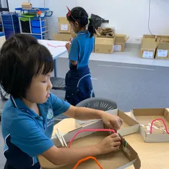 child creating an electricity box
