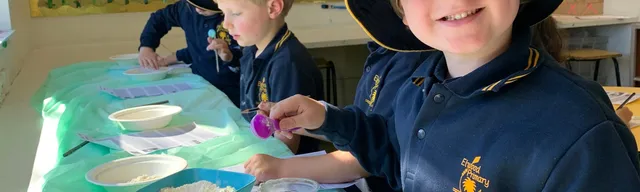 child in a school uniform smiling