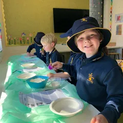 child in a school uniform smiling