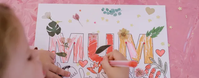 A child colouring in a card for mothers day