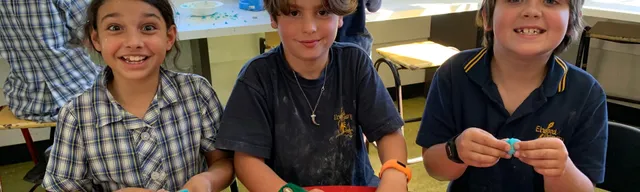 3 children smiling and moulding their experiment