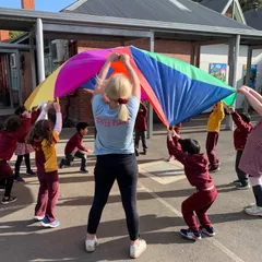 children playing under a parachute