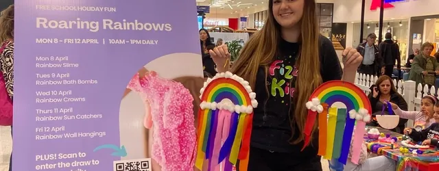A Fizz Kids staff holding crafted rainbows