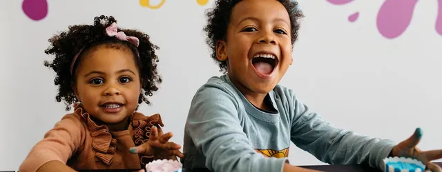 Two kids laughing with bath bombs