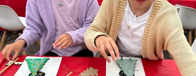 A child making a cutout christmas tree
