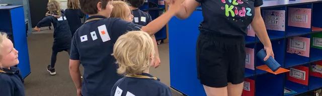 fizz kids staff high fiving children