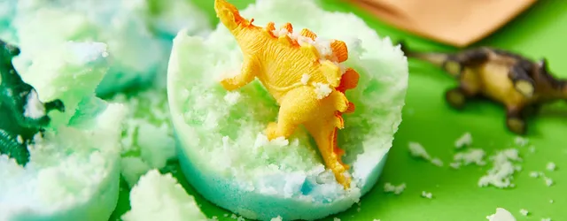 A toy dinosaur in a bath bomb