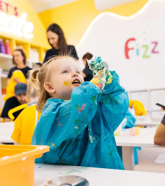 A toddler with messy hands lost in wonderment