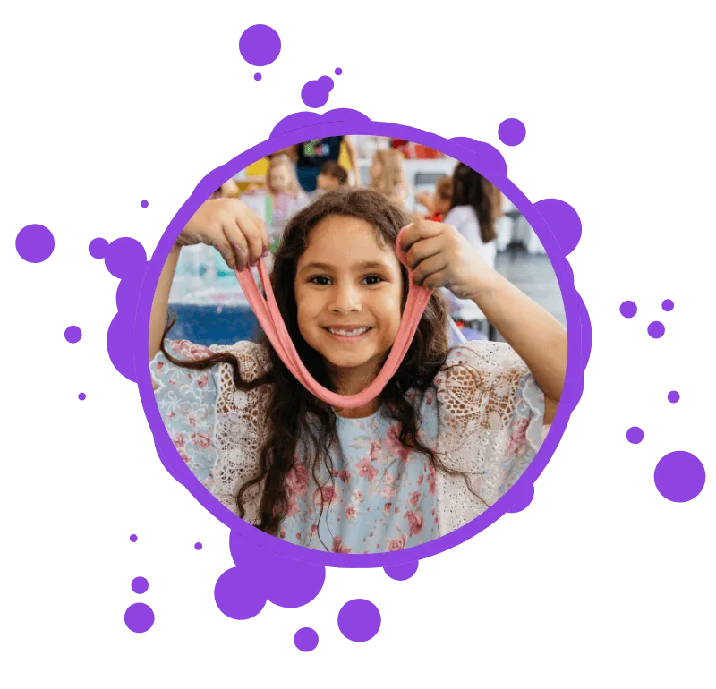 girl holding slime and smiling