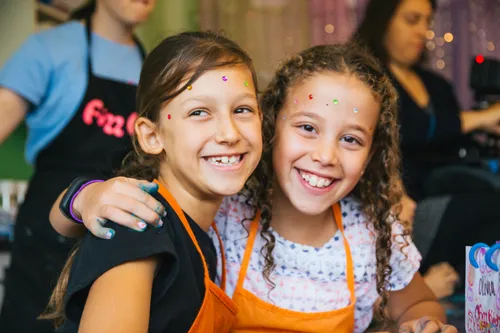 Two girls with beads laughing